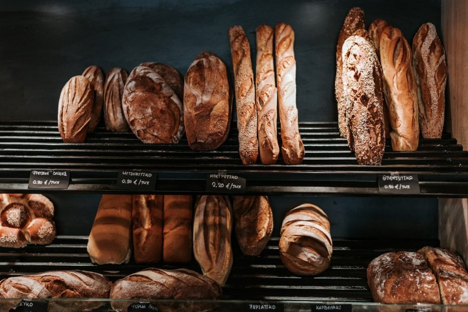 Shelves in a bakery displaying a variety of freshly baked bread