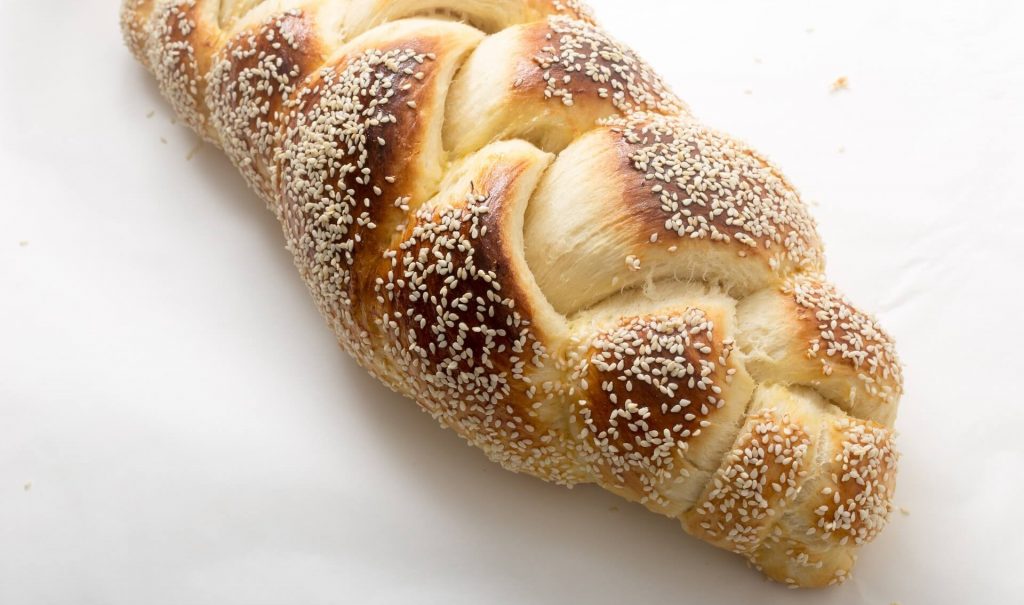 Beautifully braided challah bread with golden crust